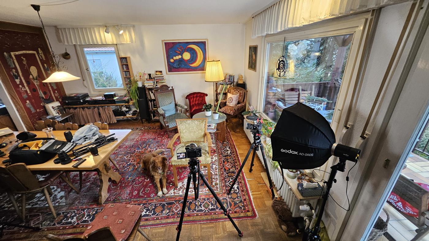 Interview set-up in a living room: camera, light and an armchair